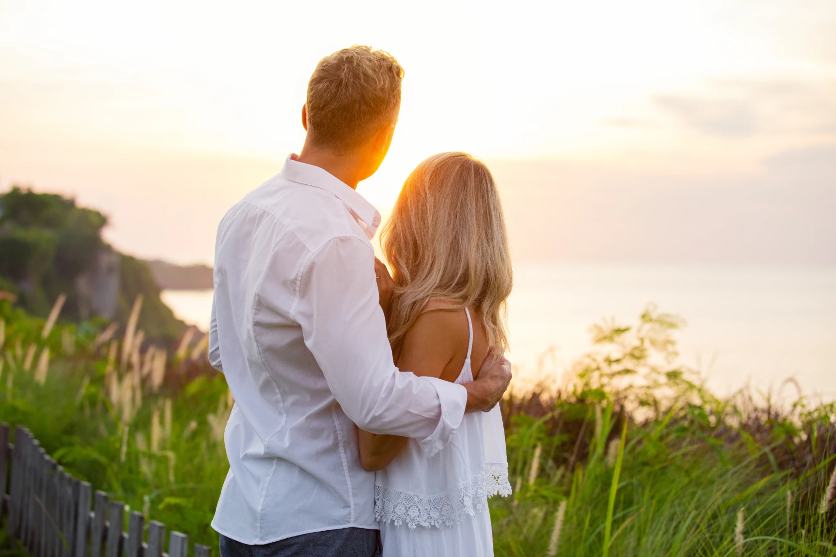 Couple embracing while watching the sunset